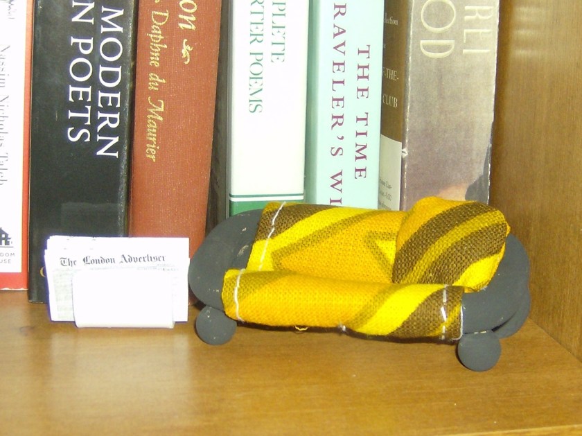 Tiny love seat and a newspaper to read. Photo by Holly Tierney-Bedord. All rights reserved.