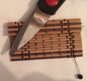 Mini blinds made from a coaster. Photo by Holly Tierney-Bedord. All rights reserved.