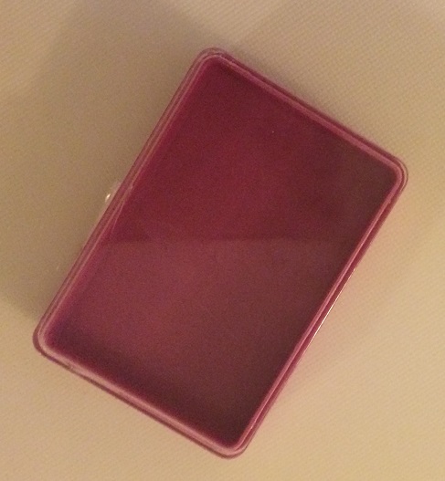 Plastic container that originally held needles and pins. This will the interior and door of my medicine cabinet. Photo by Holly Tierney-Bedord. All rights reserved.